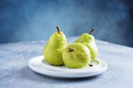 Sweet fresh green pears on the table, selective focus imageの写真素材
