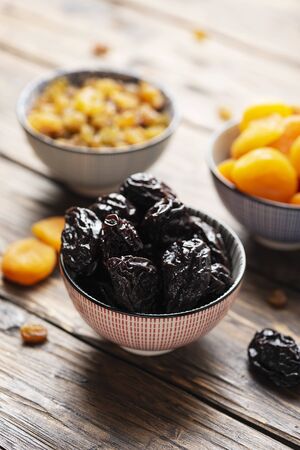 Concept of healthy meal with dried fruits: raisins, dried apricots and prunesの写真素材