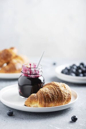 Concept of breakfast with croissant and blueberry jam, selective focus imageの写真素材