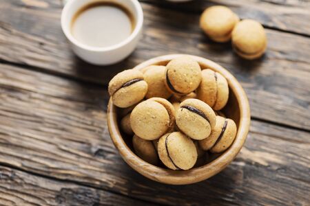Baci di dama italian hazelnut biscuits cookies with chocolate cream, rustic styleの写真素材