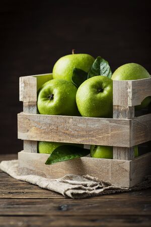 Green apples in an rustic box, selective focusの写真素材