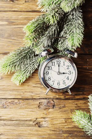 Concept of winter time change with clock and fir-treeの写真素材