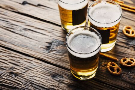 Glasses of blond beer on the wooden  table, selective focusの写真素材
