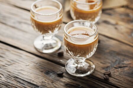 Strong coffee liqueur on the wooden table, selective focusの写真素材