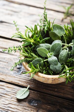 Mix of herbs: sage, thyme, rosemary on the wooden table, selective focusの写真素材