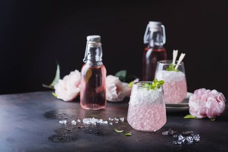 Pink cocktail with mint and crushed on the black background, selective focus imageの写真素材