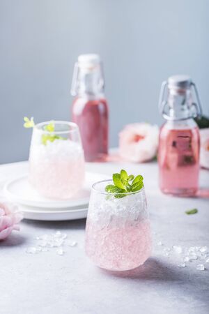 Pink cocktail with crushed ice and mint on the light background, selective focus imageの写真素材