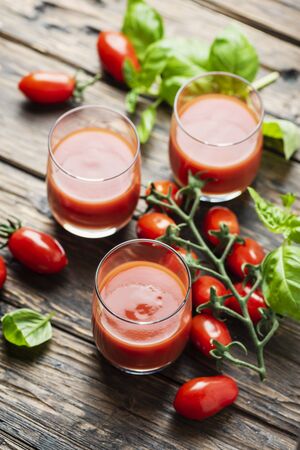 Fresh tomato juice on the wooden table, rustic styleの写真素材