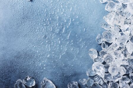 Different crystals of ice on the blue background, selective focus image with a copy space