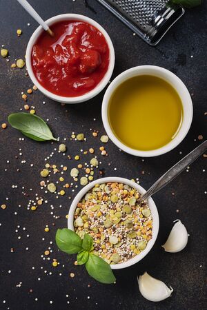 Ingredients for cookind vegetarian mix of legumes with tomato sause and basil. Concept of a healthy eating. Top view image の写真素材