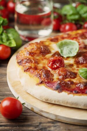 Homemade Italian pizza Margherita with tomato, mozzarella and basil, selective focusの写真素材