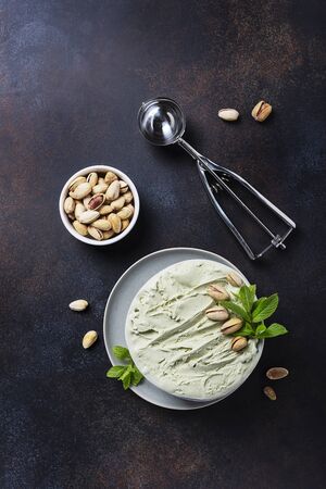 Homemade ice cream with pistachio and mint in ceramic bowl, top down view image with copy spaceの写真素材