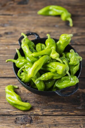 Sweet Italian green pepper friggitello on the wooden table, selective focusの写真素材