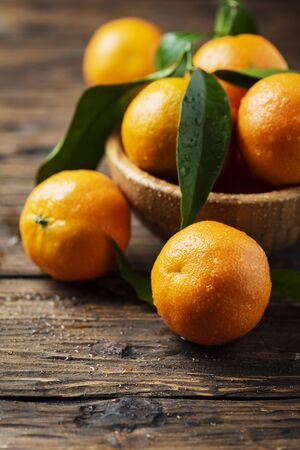 Fresh sweet mandarins on the wooden table, selective focusの写真素材