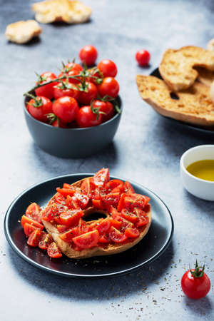 Concept of Italian food. Friselle with tomato, oil and origano. Closeup image with selective focus