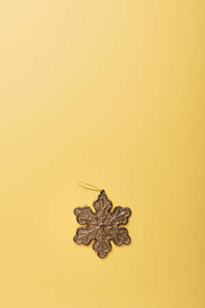 Christmas concept. Christmas card with gold star on the yellow background. Top down view with copy spaceの写真素材