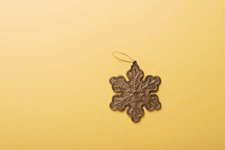 Christmas concept. Christmas card with gold star on the yellow background. Top down view with copy spaceの写真素材
