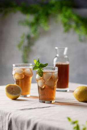 Cold summer tea with lemon and mint, selective focus imageの写真素材