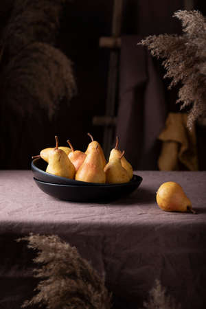 Sweet pears in rustic style on the dark background, selective focus imageの写真素材
