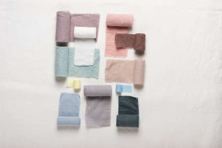 Different colors fabric samples on the white table, selective focus imageの写真素材