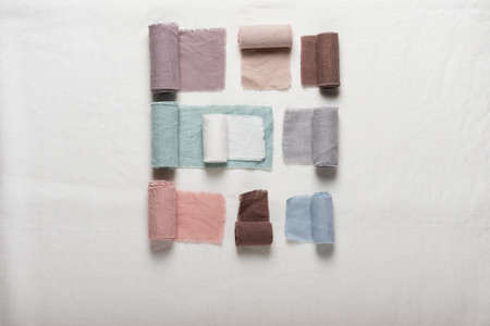 Different colors fabric samples on the white table, selective focus imageの写真素材