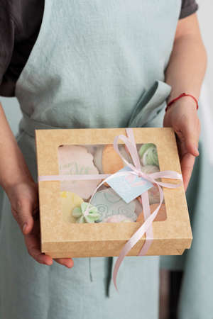 Woman holding Easter gift box with cookies, selective image focusの写真素材