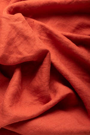Stonewashed linen fabric in brick color, sewing concept, selective focus imageの写真素材