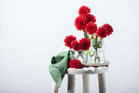 Red amazing flowers dahlias on the wooden table, selective focus imageの写真素材