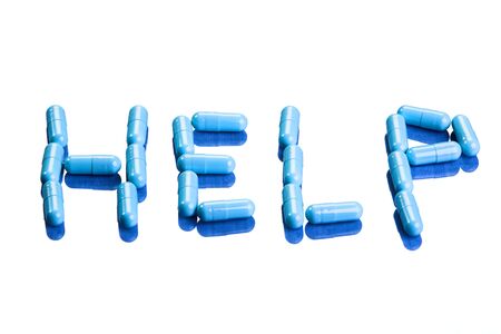 An arrangement of blue pills spelling out HELPの写真素材