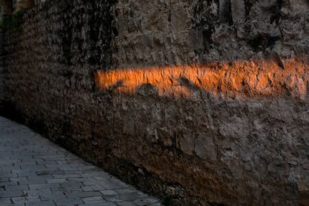 Beam of light shining on a stone wall.の写真素材