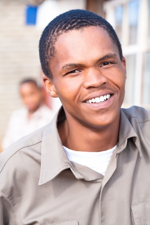 Friendly young black african male close up with another boy in the back.の写真素材