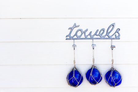 Towel hanger with blue glass balls hanging from the top.の写真素材