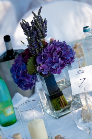 Chrismas roses and Lavenders on white table cloth with candles の写真素材