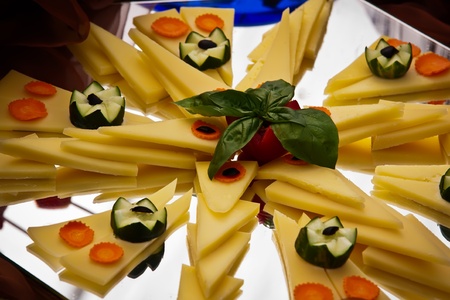 Cheese platter with carrots and cucumber の写真素材