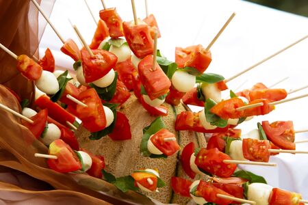 Tomatoes with cheese on a stick の写真素材