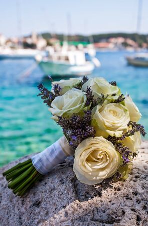 Wedding bouquet on rock by the ocean の写真素材