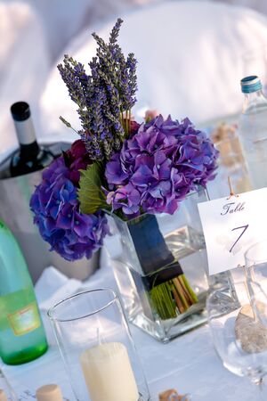 Chrismas roses and Lavenders on white table cloth with candles の写真素材