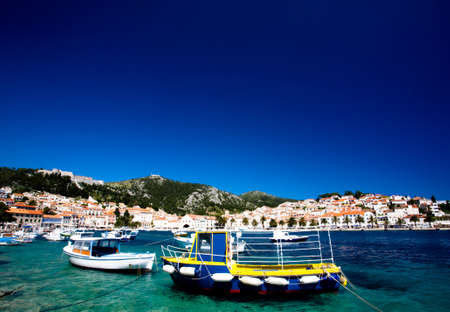 Yellow fishing boat anchered in the Croation harbour の写真素材