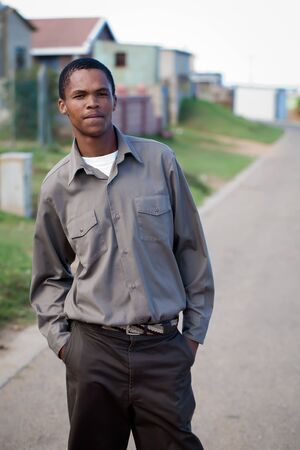 Young man posing in the street of shack town.の写真素材