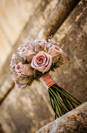 Pink roses with the same coloured ribbon on steps.の写真素材