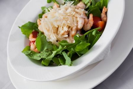Prawn salad provided with onions, leaves and tomatoes.の写真素材