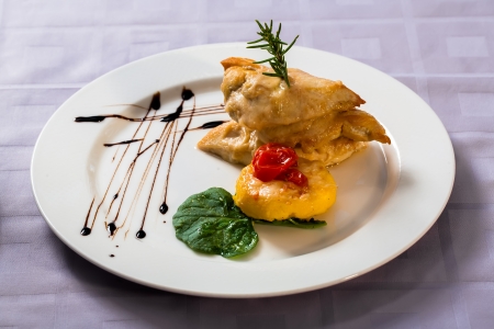 Chickens on three layers with pumpkin cake and tomatoes.の写真素材