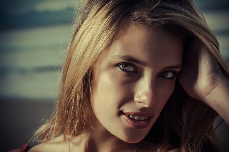 Female close up of a model on the beach with hands in the hair.の写真素材