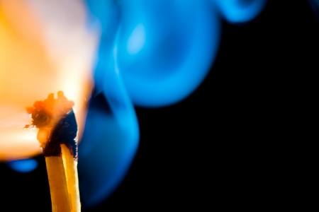 A burning match with the smokey edges at the back.の写真素材