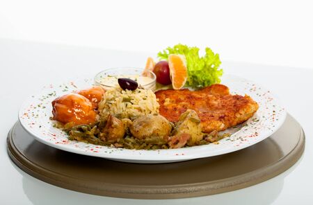 Chicken and rice is served with nice side dishes の写真素材