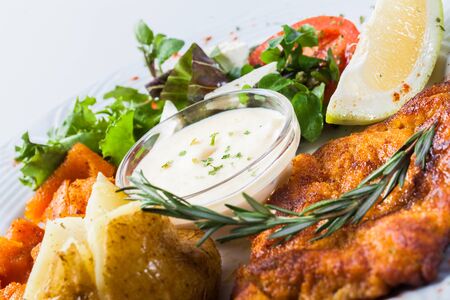 Potatoes and pumpkin is served with salad and cheese sauce の写真素材