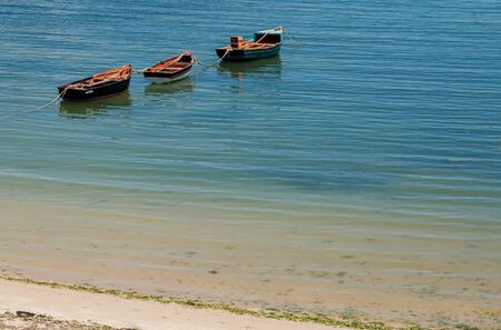Three boats is drifting around at the start of coast の写真素材