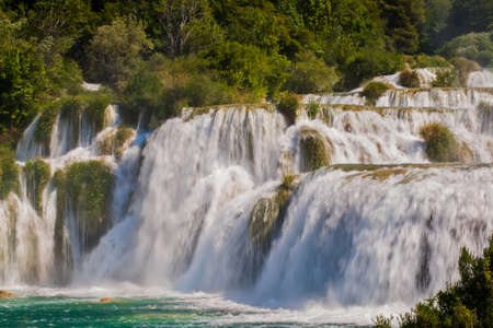 There is a big waterfall coming down in a rush の写真素材