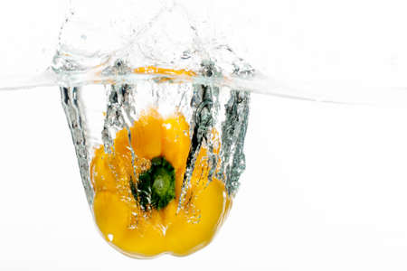 The yellow pepper make a beautiful glance in the wavey water の写真素材