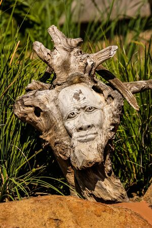 Wooden art with a crafty face.の写真素材